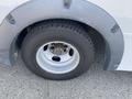 Close-up of the wheel and tire of a 2017 Chevrolet Express showing the tire tread and hubcap design