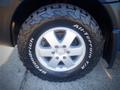 A close-up of a silver wheel with a black all-terrain tire featuring the BFGoodrich logo and the Mercedes-Benz emblem in the center