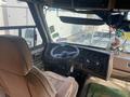 Interior of a 1987 Chevrolet Fleetwood Pace Arrow featuring a plush driver’s seat and a dashboard with controls and radio system