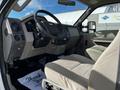 Interior of a 2008 Ford F-550 showing the driver's seat steering wheel and dashboard with controls and a light-colored fabric upholstery