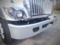 A 2016 International WorkStar 7500 truck with a shiny chrome grill and a silver front bumper featuring two openings