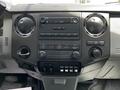 Interior dashboard of a 2016 Ford F-550 featuring a central control panel with audio and climate controls as well as a digital clock display