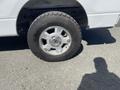 A 2012 Ford F-150 with a silver alloy wheel and all-terrain tire visible in the foreground