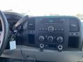 Dashboard of a 2013 Chevrolet Silverado 1500 with a radio and climate control system visible along with a key in the ignition