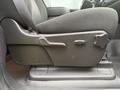 A black fabric car seat from a 2013 Chevrolet Silverado 3500HD with adjustable levers for height and tilt settings