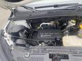 The engine compartment of a 2018 Buick Encore featuring the ECOTEC engine with various components and hoses visible
