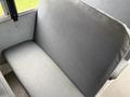 A gray vinyl bus seat with a slightly worn surface, designed for use in a 2013 International 3000 model