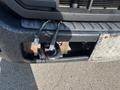 A 2015 Ford F-450 SD with visible rust and a towing hitch at the front along with electrical wires attached to the bumper
