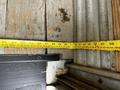 2021 Ford E-450 with a tape measure laid across a wooden surface indicating measurements