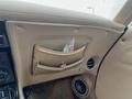 Interior view of a 1970 Chevrolet Corvette showing beige leather upholstery with a storage pocket and a speaker visible