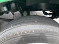 Close-up of a worn tire on a 2013 Kenworth T370 showing distinct tread patterns and wear marks on the surface