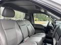 Interior view of a 2018 Ford F-550 showing two leather front seats with armrests and a dashboard featuring controls and a steering wheel