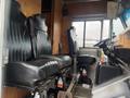 Interior of a 2012 Workhorse W62 featuring two black leather seats and a steering wheel with controls