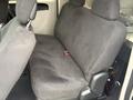 A rear bench seat from a 2011 Dodge Grand Caravan covered in gray fabric with headrests and a seatbelt visible