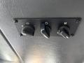 Control panel with three knobs for various settings in a 2006 E-One Typhoon vehicle