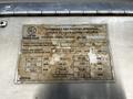 A metal identification plate from a 2006 Emergency One Fire Truck displaying various specifications and capacity details for the fire fighting apparatus