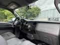 Interior view of a 2015 Ford F-350 SD featuring a grey dashboard with controls and spacious seating in a work truck style