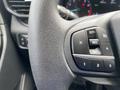Close-up of the steering wheel controls in a 2021 Ford Explorer featuring buttons for cruise control and settings
