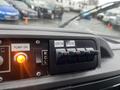 Dashboard controls of a 2009 Ford Econoline featuring switches for auxiliary functions and an illuminated indicator light