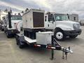 A 2005 Trailerman Generator Trailer with a white generator unit on top a black trailer chassis featuring a storage box at the front and a hitch for towing