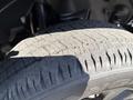 Close-up of a tire from a 2021 Jeep Gladiator showing the tread pattern and detail of the rubber surface