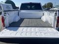 A 2017 Ford F-150 with an open truck bed showing a textured floor and side panels