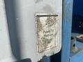 A weathered sticker on a 1997 Genie S-65 4X4 lift indicating power to platform with faded graphics and text