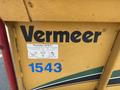 A yellow Vermeer Corporation BC1200XL with large black lettering displaying "Vermeer" and a label for contact information