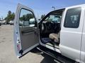 A 2008 Ford F-450 SD with the driver's side door open showing the interior and seats