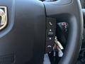 Close-up of the steering wheel in a 2016 RAM Promaster featuring control buttons for phone and other functions