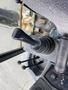 Close-up of the joystick and controls inside a 2012 John Deere 310SJ excavator with levers and a control panel visible