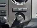 Dashboard controls of a 2014 Ford F-250 SD including climate control knobs and a 12V power outlet