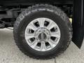 Close-up of a silver alloy wheel with a rugged Goodyear Wrangler tire mounted on a 2020 Ford F-350