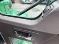 Interior view of a 2013 Kenworth T370 showing the door handle and window controls near the driver's side window
