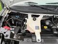 A 2020 Chevrolet Express engine compartment showing the coolant reservoir and various engine components