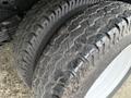 Close-up of two worn tires from a 2019 Ford Econoline showing deep treads and visible signs of wear and tear on the rubber surface