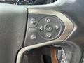 Steering wheel control panel of a 2017 Chevrolet Silverado 1500 featuring buttons for audio and cruise control settings