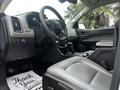 Interior view of a 2018 Chevrolet Colorado showing the dashboard steering wheel and leather seats