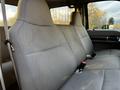 A gray interior of a 2008 Ford F-250 SD showing two spacious bench seats with seat belts