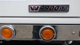 A close-up of the nameplate and lights on a 2019 Western Star Trucks 4900 featuring the model number 4900SB and rounded orange lights