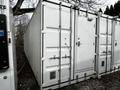 A 40 foot custom climate controlled storage container with white walls and metal doors featuring a secure locking mechanism and ventilation holes