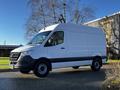 A 2021 Mercedes-Benz Sprinter van with a white exterior and black accents parked on a driveway