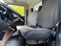 Interior view of a 2021 Hino 338 showing the driver's seat with a textured fabric design and the steering wheel in close proximity