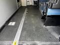 Interior floor of a 2013 Chevrolet Express van featuring a rubber surface and a track for a wheelchair lift with a driver's seat visible to the side