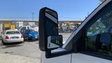 2011 Chevrolet Express van with a side mirror prominently displayed in the foreground