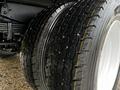 Close-up of a tire on a 2006 Hino 155 showcasing its tread pattern and rubber surface