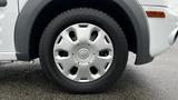 Close-up of a silver wheel and tire from a 2012 Ford Transit showing the tire tread and alloy wheel design