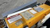 A yellow control panel with danger warnings and operational instructions on a 2009 International 4300 vehicle