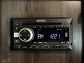 A Jensen JWM4352 stereo system with Bluetooth capability featuring an LCD display showing AM 1221 and various buttons for control