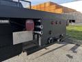 A black 2017 Chevrolet Silverado 3500HD with a flatbed featuring tool boxes red lights and multiple hydraulic connectors on the rear end